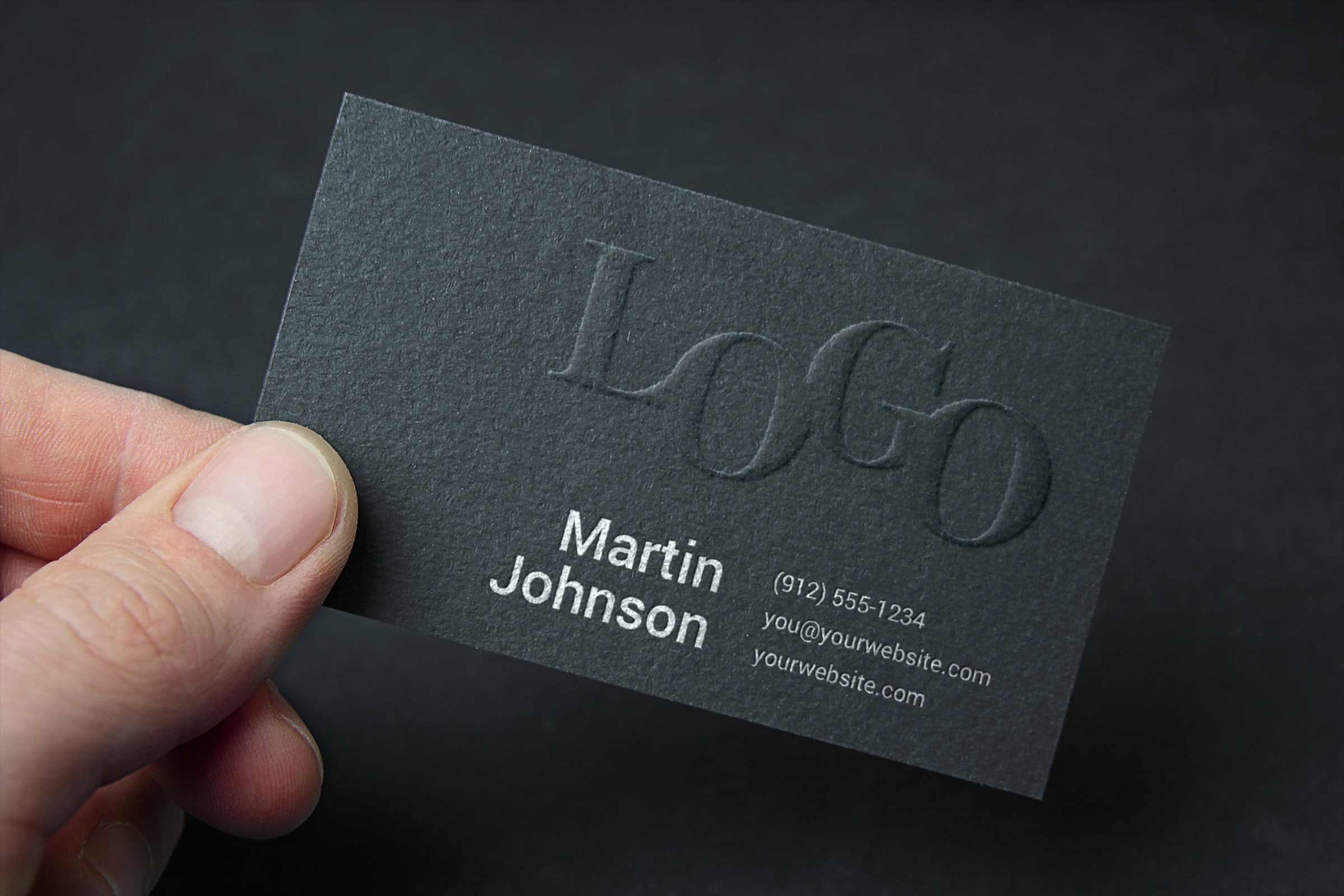 A photograph of an embossed busness card.